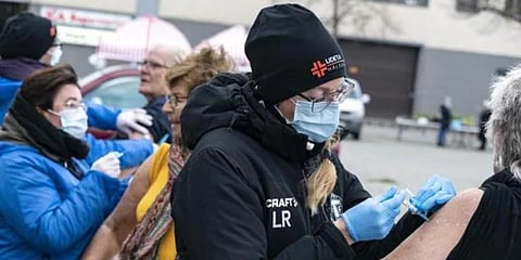 Nursing staff administer flu vaccines to high-risk group patients, outdoors to prevent the spread of the coronavirus, in Trelleborg, southern Sweden. (Photo | AP)
