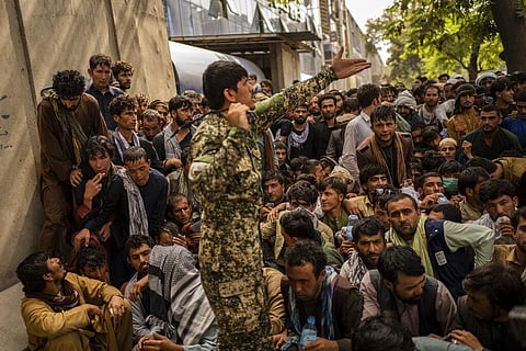 Afghans wait in front of a bank as they try to withdraw money in Kabul, Afghanistan. (Photo | AP)