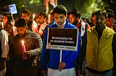 Members of Indian Youth Congress(IYC) stage a candlelight march protest march in memory of the farmers who died during the farmers' movement at Jantar Mantar, in New Delhi. (Photo | PTI)