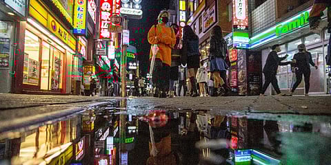 People walk along the streets full of shops, bars and restaurants Friday night, Oct. 1, 2021, in Shibuya, an entertainment district of Tokyo. (Photo | AP)