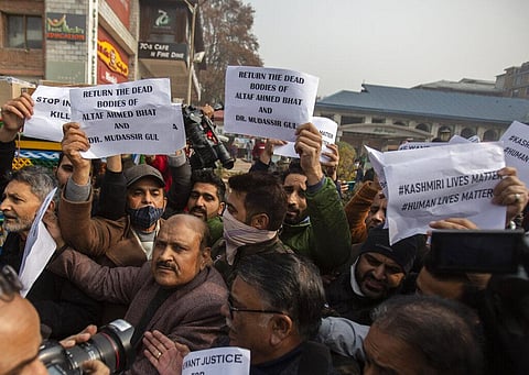Members of Jammu and Kashmir People's Conference hold placards as they shout slogans during a protest demanding the return of dead bodies of civilians for proper burial, in Srinagar. (Photo | AP)