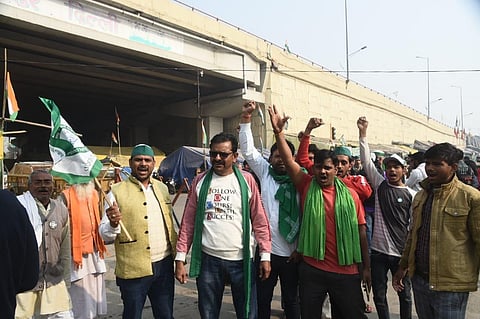 Farmers celebrating after PM Modi decided to repeal three farm laws, at Gazipur border in New Delhi on Friday. Express Photo Parveen Negi