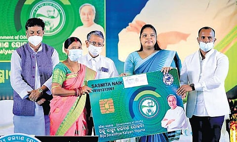 A beneficiary receiving the BSKY smart health card on Thursday. (Photo| EPS)