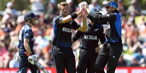 New Zealand bowler Corey Anderson is congratulated by teammate Martin Guptill (R) after dismissing Scotland batsman Richie Berrington (L) during their 2015 World Cup match in Dunedin. (File photo| AFP