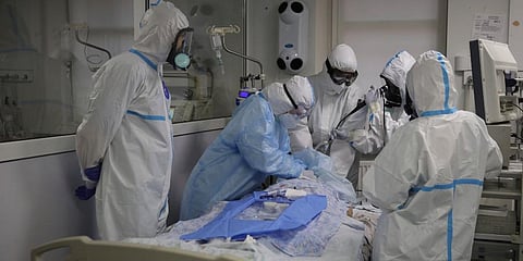 Medics wearing special suits to protect against coronavirus treat a patient with coronavirus at an ICU at the Regional Clinical Hospital 1, in Krasnodar, south Russia. (Photo | AP)
