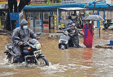 Commuters struggle near Indira Gandhi Square in Puducherry amid water stagnation following heavy rains. (Photo | Pattabi Raman, EPS)