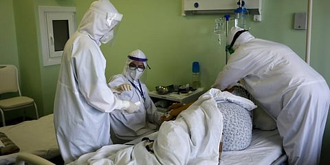 Medics wearing a special suit to protect against coronavirus treat a patient with coronavirus at an ICU of a hospital in Kalach-on-Don, 73 km south-east of Rostov-on-Don, Russia. (Photo | AP)