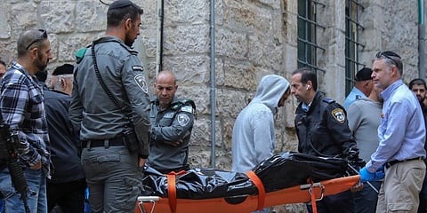 Zaka Rescue and Recovery team carry the body of a Palestinian man who was fatally shot by Israeli police after he killed one Israeli in a shooting attack in Jerusalem's Old City. (Photo | AP)