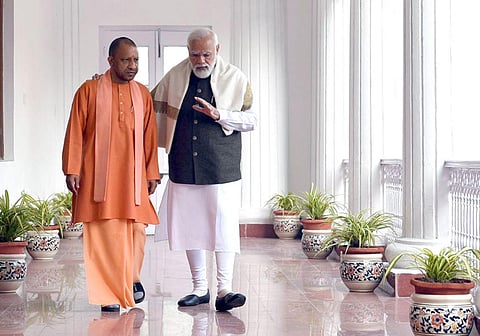 The photograph doing rounds on Social media showing PM Narendra Modi takes a stroll with UP CM Yogi Adityanath engrossed in deep discussion in the corridors of Lucknow Raj Bhawan (Photo | Twitter)