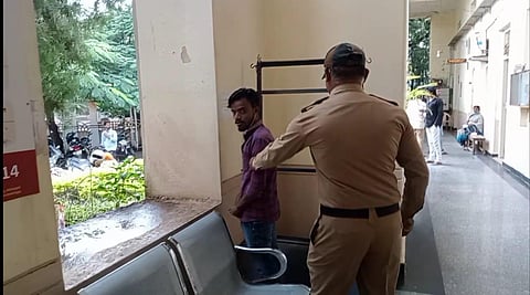 A policeman trying to stop a protester at the Municipal Council office on Tuesday morning (Photo | Special arrangement)