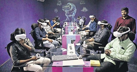 Participants at the annoucement of Cymax Techno-Park experience the virtual reality wearable devices in Hyderabad. (Photo | Vinay Madapu, EPS)