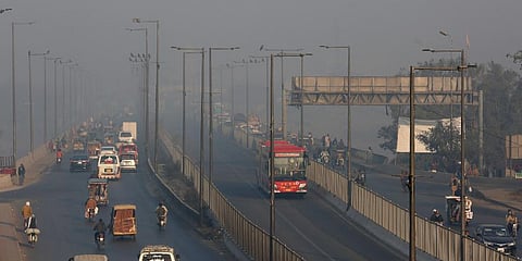 Vehicles drive along a highway as smog envelops the area of Lahore, Pakistan. (Photo | AP)