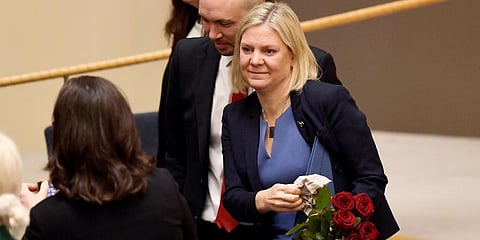 Sweden's Finance Minister and Scocial Democratic Party leader Magdalena Andersson holds flowers after a vote appointing her as Sweden's new PM, in the Swedish Parliament Riksdagen. (Photo | AP)