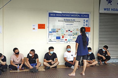 People wait in line from early morning to receive a shot of COVID-19's vaccine at a clinic in Singapore (Photo | AP)