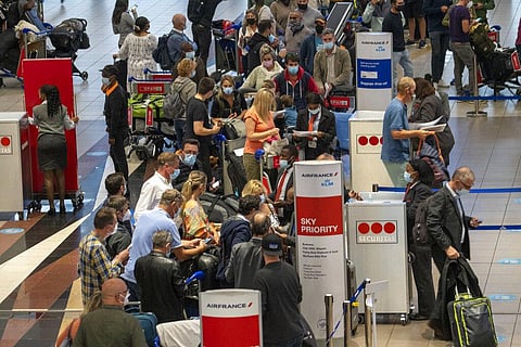 People lineup to get on the Air France flight to Paris at OR Tambo's airport in Johannesburg, South Africa', Friday Nov. 26, 2021. (Photo | AP)