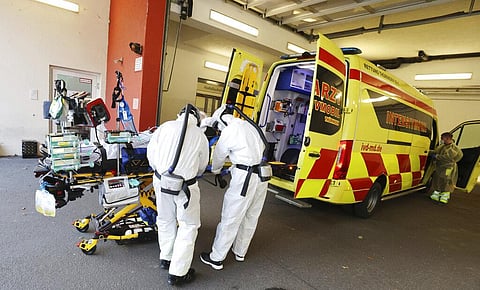A patient with COVID-19 disease gets prepared to be transferred from Thueringen Kliniken hospital to a hospital in Hanover. (Photo | AP)