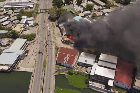 In this image made from aerial video, smoke rises from burning buildings during a protest in the capital of Honiara, Solomon Islands. (Photo | AP)