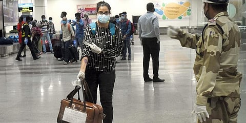 A woman passenger shows her stamped hand as she exits Bhubaneswar airport after arriving from Bengaluru. (Photo | Biswanath Swain, EPS)