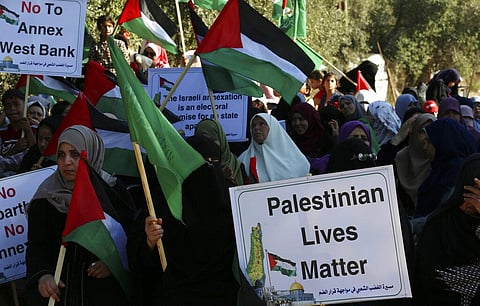 Hamas supporters wave their green and national flags during a protest against Israel's plan to annex parts of the West Bank. (File photo| AP)
