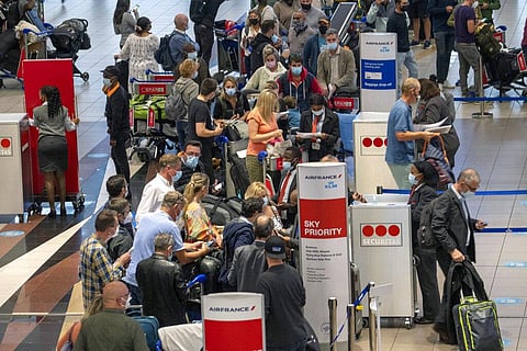 People line up to get on the Air France flight to Paris at OR Tambo International Airport in Johannesburg, South Africa. (Photo | AP)