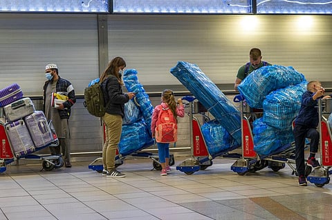 People line up to get on an overseas flight at OR Tambo International Airport in Johannesburg, South Africa. (Photo | AP)