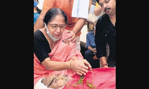 Prasanna, Bichu Thirumala’s wife, pays last respects to her husband at their residence at Vettamukku in Thiruvananthapuram. Their son Suman is also seen | B P Deepu