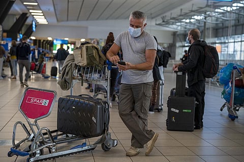 People lineup to get on the Air France flight to Paris at OR Tambo's airport in Johannesburg, South Africa' on November 26, 2021. (Photo | AP)