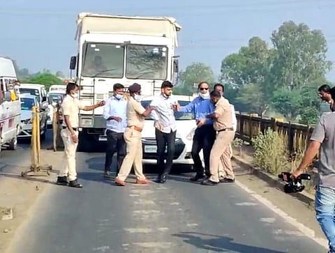 Officials trying to control the angry doctor at the checkpost. (Photo | Express)