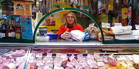 A vendor sells food items, at a food market in Budapest, Hungary. (Photo | AP)