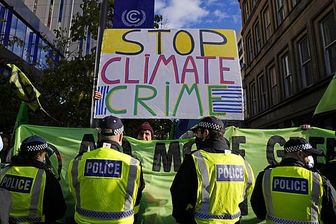 Extension Rebellion activists take part in a demonstration against 'Greenwashing' near the COP26 U.N. Climate Summit in Glasgow. (Photo | AP)