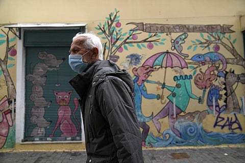 A man wearing a face mask to protect against coronavirus walks in Athens, Greece (Photo | AP)