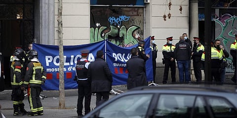 Policemen and firefighters work at the scene where a fire broke out in a building, in Barcelona. (Photo | AP)
