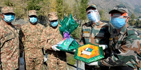 Indian and Pakistani Army personnel exchange sweets on the occasion of Diwali on the Line of Control. (Photo | PTI)