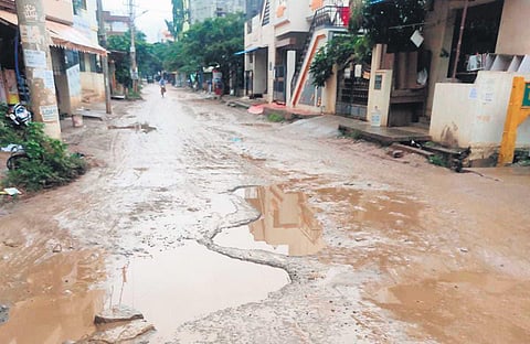 A pothole-ridden stretch at Manjunath Nagar in KR Puram, Bengaluru | Express