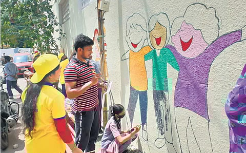 Students painting the walls of AJS Nidhi High School