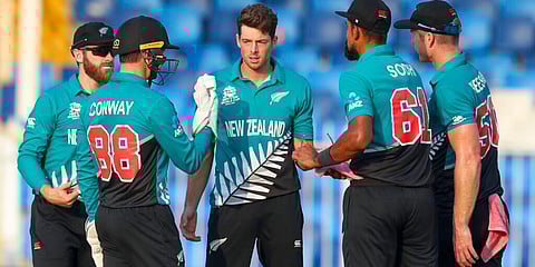 New Zealand's Mitchell Santner, centre, is congratulated by teammates after taking a wicket. (Photo | AP)
