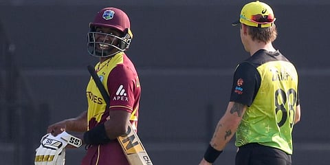 West Indies' Dwayne Bravo (L) talks to Australia's Adam Zampa as walks from the field. (Photo | AP)