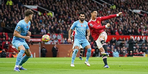 Cristiano Ronaldo (in red) kicks the ball during the English Premier League match between Manchester United and Manchester City at Old Trafford. (Photo | AP)