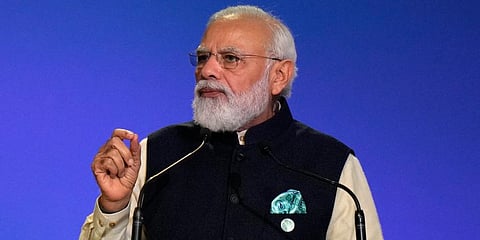 PM Narendra Modi gestures as he makes a statement at the COP26 U.N. Climate Summit in Glasgow, Scotland. (Photo | AP)