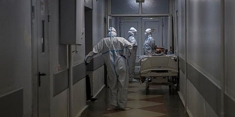 Medical staff wearing special suits prepare to move a patient with coronavirus at an ICU at the Regional Clinical Hospital 1, in Krasnodar, south Russia, Tuesday, Nov. 2, 2021. (Photo | AP)