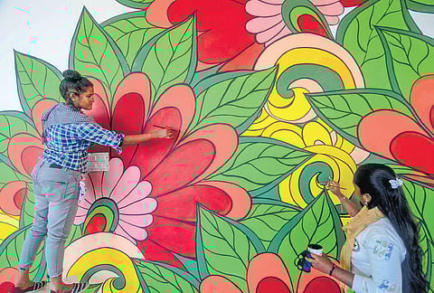 Kaveri, the disabled 26-year-old painter, covers walls of the new Palayamkottai Bus Stand in Tirunelveli with colours as part of the Smart Cities Mission Project | V KARTHIKALAGU