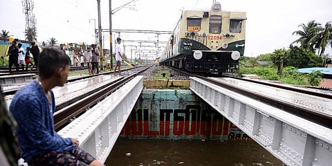 People wade through a waterlogged road following heavy rains at Vyasarpadi in Chennai. (Photo| Debadatta Mallick, EPS)