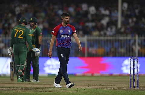 England's Mark Wood reacts after he was hit for a four by South Africa's Aiden Markram during the Cricket Twenty20 World Cup match. (Photo | AP)