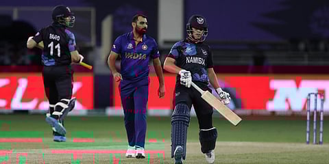 India's Mohammed Shami watches as Namibia's Michael Van Lingen (R) and Stephan Baard run between the wickets. (Photo | AP)