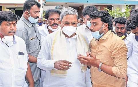 Congress Legislature Party leader Siddaramaiah listens patiently to a supporter in Mysuru on Monday  | Udayshankar S