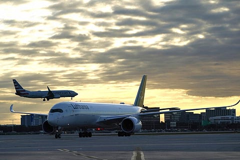 A Lufthansa flight arrives from Munich, Germany as an American Airlines plane comes in for a landing at Miami International Airport. (Photo | AP)
