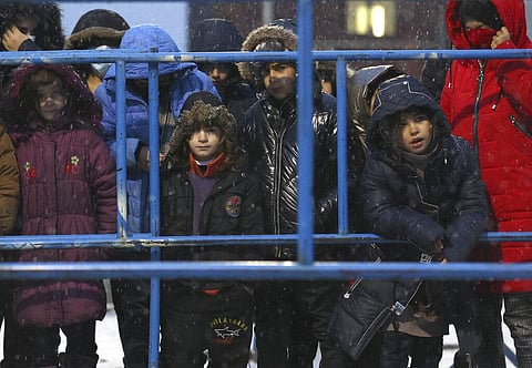 Migrants stands in queue to receive a hot food at a logistics center at the checkpoint logistics center 'Bruzgi' at the Belarus-Poland border (Photo | AP)