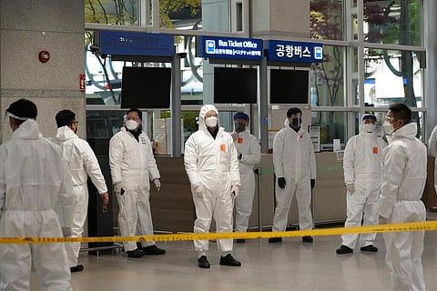Quarantine officers wait to guide travelers at the arrival hall of the Incheon International Airport In Incheon (Photo | AP)