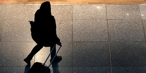 A woman pulls a suitcase at Lisbon's international airport. (Photo | AP)