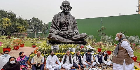 Congress senior leader Mallikarjun Kharge with suspended MPs of Rajya Sabha during a dharna near Mahatma Gandhi statue demanding revocation of their suspension. (Photo | PTI)
